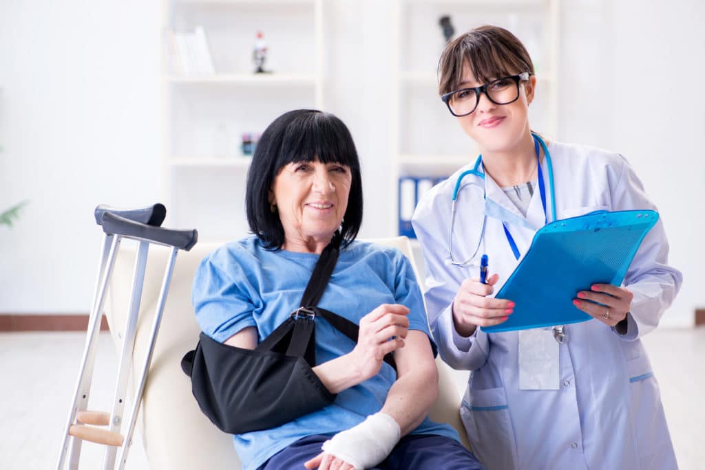 Doctor examining old mature woman after incident